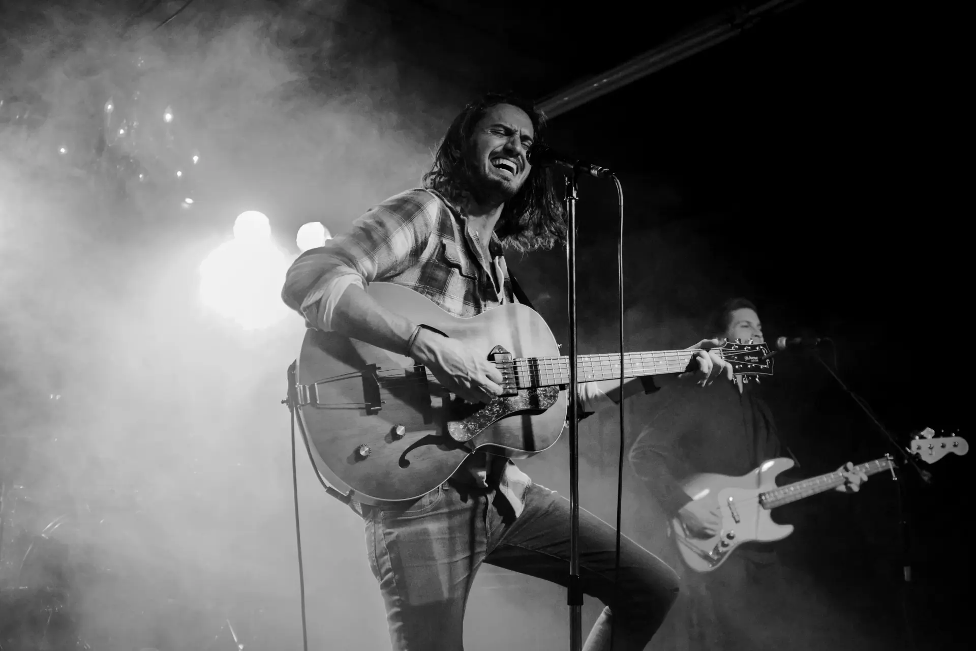 A guitarist performing under live lights