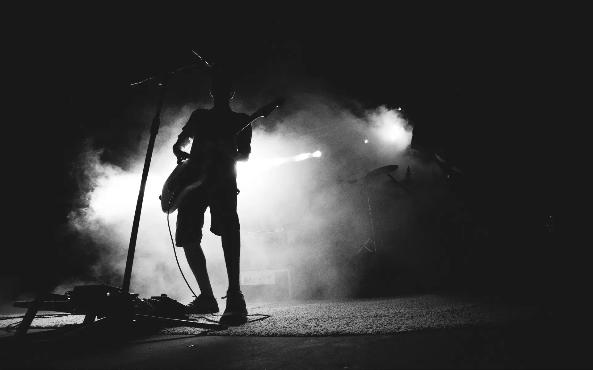 An artist performing in silhouette